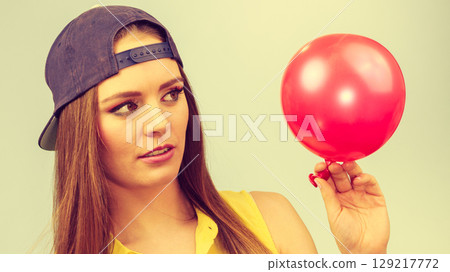 Teenage girl with red balloon. 129217772