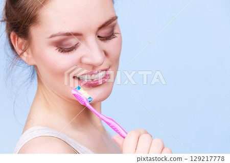 Woman brushing cleaning teeth Woman brushing cleaning teeth 129217778