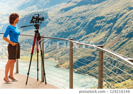 Tourist with camera on tripod in Norway nature 129218148