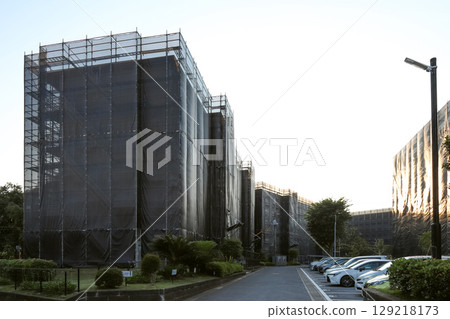Large-scale exterior wall construction of an apartment building at dusk 129218173