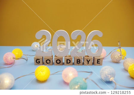 Goodbye 2026 letters with LED cotton balls decoration on blue background Goodbye 2026 letters with LED cotton balls decoration on blue background 129218255