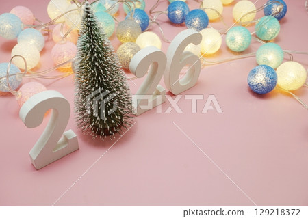 Happy New Year 2026 festive background with space on pink background Happy New Year 2026 festive background with space on pink background 129218372