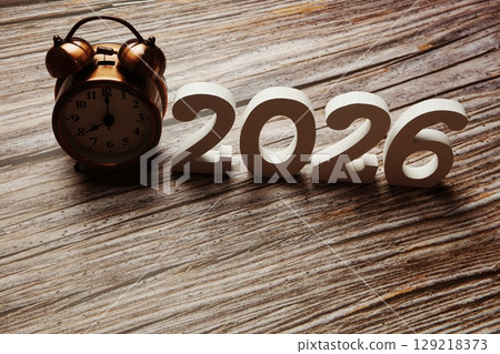 Happy New Year 2026 festive background with space on wooden background 129218373
