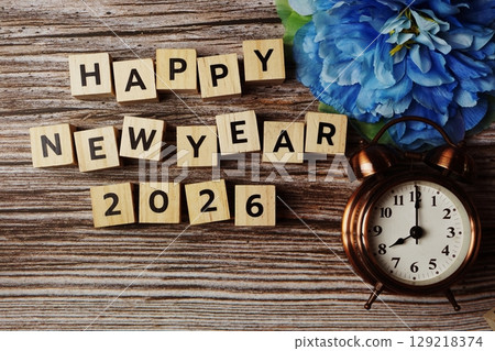 Happy New Year 2026 with alarm clock on wooden background 129218374