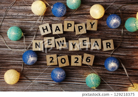 Happy New Year 2026 decorate with LED cotton ball on wooden background Happy New Year 2026 decorate with LED cotton ball on wooden background 129218375