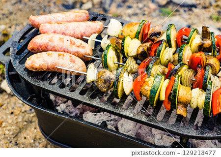 Grilled vegetables and meat on barbecue grill 129218477