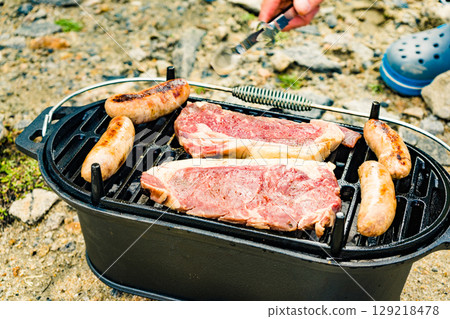 Grilled meat on barbecue grill 129218478