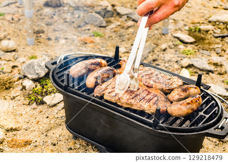 Grilled meat on barbecue grill 129218479