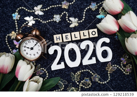 Hello 2026 alphabet letter decorate with alarm clock on blue knitted fabric background 129218539