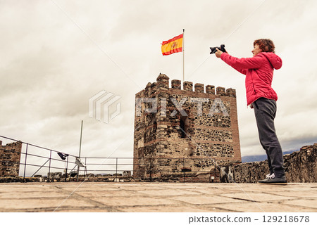 Tourist with camera on Sohail Castle in Fuengirola, Spain 129218678