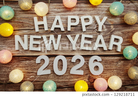 Happy New Year 2026 alphabet letter decorate with LED cotton balls on wooden background Happy New Year 2026 alphabet letter decorate with LED cotton balls on wooden background 129218711