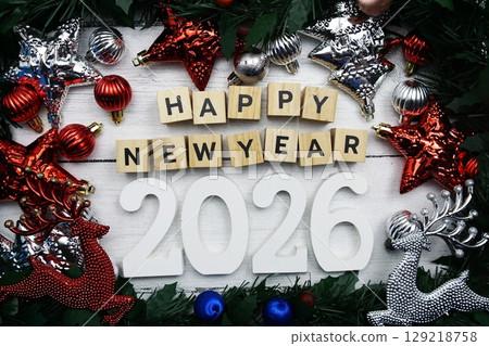 Happy New Year 2026 alphabet letters and christmas decoration on wooden background Happy New Year 2026 alphabet letters and christmas decoration on wooden background 129218758