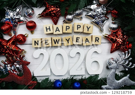 Happy New Year 2026 alphabet letters and christmas decoration on wooden background Happy New Year 2026 alphabet letters and christmas decoration on wooden background 129218759
