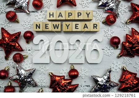Happy New Year 2026 alphabet letters and christmas decoration on wooden background Happy New Year 2026 alphabet letters and christmas decoration on wooden background 129218761
