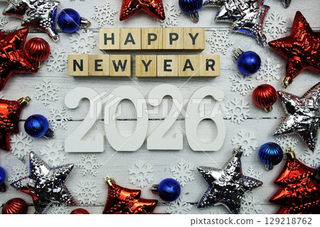 Happy New Year 2026 alphabet letters and christmas decoration on wooden background Happy New Year 2026 alphabet letters and christmas decoration on wooden background 129218762
