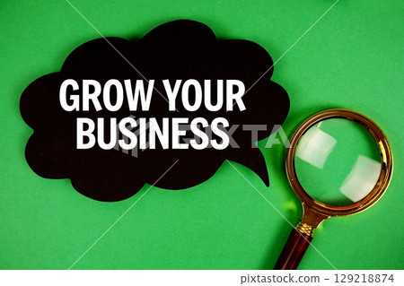 Grow Your Business text with speech bubble and magnifying glass on green background 129218874