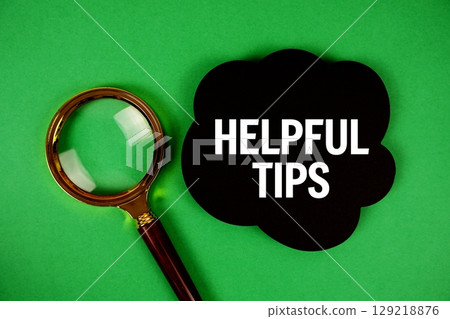 Helpful Tips text with speech bubble and magnifying glass on green background Helpful Tips text with speech bubble and magnifying glass on green background 129218876