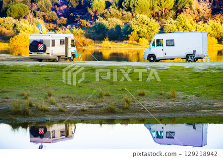 Campers rv camping at lake shore. Alentejo Portugal. Campers rv camping at lake shore. Alentejo Portugal. 129218942