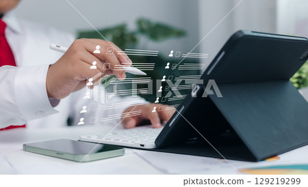 Digital HR management, staff workflow, and paperless human resources system. Customer profile selection and employee checklist interface on digital tablet using stylus. 129219299