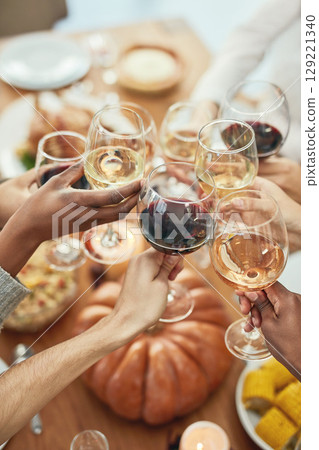 Closeup, hands and wine for celebration, group and dining table for lunch together. Top view, toast and glasses for alcohol, food and people success for holiday, champagne and cheers for happiness. Closeup, hands and wine for celebration, group and dining table for lunch together. Top view, toast and glasses for alcohol, food and people success for holiday, champagne and cheers for happiness. 129221340