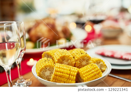 Corn, healthy and lunch on a table for a celebration, Christmas and nutrition in a house. Food, holiday and dinner in the dining room to celebrate Thanksgiving with a feast and vegetables at home Corn, healthy and lunch on a table for a celebration, Christmas and nutrition in a house. Food, holiday and dinner in the dining room to celebrate Thanksgiving with a feast and vegetables at home 129221341