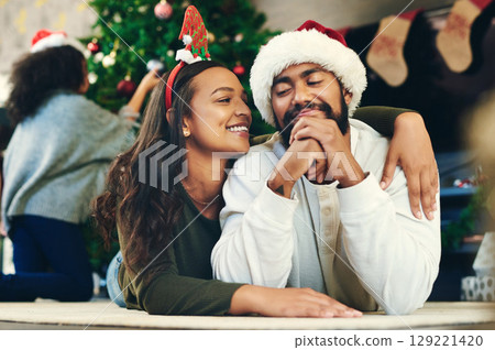 Couple hug, christmas and love at party, celebration and happiness on holiday in home living room. Man, woman and embrace to celebrate, romance and happy with smile, care and lounge in family home Couple hug, christmas and love at party, celebration and happiness on holiday in home living room. Man, woman and embrace to celebrate, romance and happy with smile, care and lounge in family home 129221420