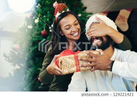 Couple, Christmas gift surprise and holiday celebration, happy together with cover eyes and Christmas tree. Celebrate at home, Mexican man with woman, decoration and present secret with love. 129221421