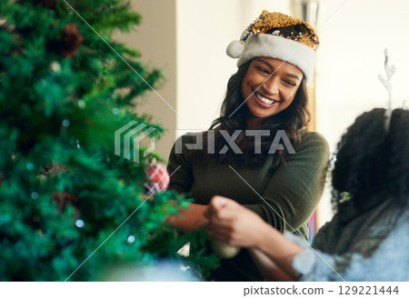 Mother, child and christmas, tree decoration and holiday celebration, happy smile and love together in home. Latino woman, child and happiness on xmas, celebrate and christmas tree in family home 129221444