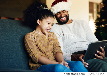 Tablet, video call or movie with black family on christmas for bond, happiness and smile. Care, dad and child on sofa for festive holiday internet streaming together in happy family home. Tablet, video call or movie with black family on christmas for bond, happiness and smile. Care, dad and child on sofa for festive holiday internet streaming together in happy family home. 129221454