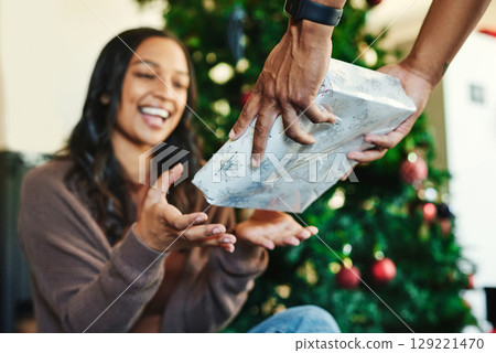 Couple, bonding or hands and christmas gift box in house or home living room for holiday celebration, festive vacation or surprise giving. Smile, happy or xmas woman with present from man in Portugal Couple, bonding or hands and christmas gift box in house or home living room for holiday celebration, festive vacation or surprise giving. Smile, happy or xmas woman with present from man in Portugal 129221470