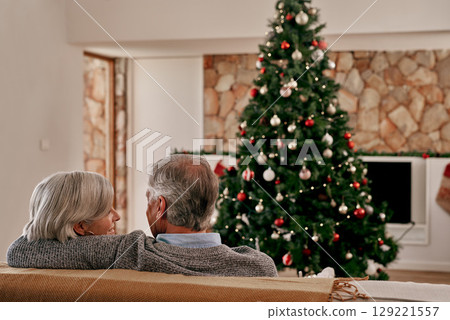 Elderly couple, hug and relax on sofa by Christmas tree for relationship bonding or quality time together at home. Senior man holding woman on living room couch for holiday, vacation or new year Elderly couple, hug and relax on sofa by Christmas tree for relationship bonding or quality time together at home. Senior man holding woman on living room couch for holiday, vacation or new year 129221557