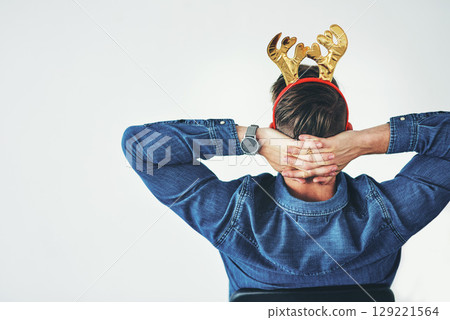 Businessman, relax and christmas reindeer antlers on office mockup background, company wall space or small business startup. Creative designer, hands behind head and done with festive season success Businessman, relax and christmas reindeer antlers on office mockup background, company wall space or small business startup. Creative designer, hands behind head and done with festive season success 129221564