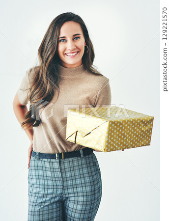 Christmas, birthday or holiday with woman giving gift or present to celebrate and surprise on a studio background. Portrait of a female with a smile, happiness and kindness holding a mockup gift box Christmas, birthday or holiday with woman giving gift or present to celebrate and surprise on a studio background. Portrait of a female with a smile, happiness and kindness holding a mockup gift box 129221570