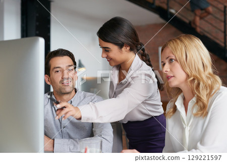 Meeting, collaboration and explain with a business woman and team talking while working on a computer together. Teamwork, planning and strategy with a female employee helping a colleague in an office 129221597
