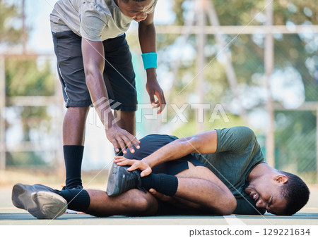 Basketball player, man with injury, ankle pain and sports trauma, fitness emergency and first aid accident or risk and wound. Black man, basketball court and leg pain, muscle inflammation and problem 129221634