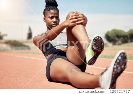 Black woman, runner stretching and training for race on racing track in stadium with focus, determination and motivation. Outdoor fitness workout, running sports exercise and athlete stretch on floor Black woman, runner stretching and training for race on racing track in stadium with focus, determination and motivation. Outdoor fitness workout, running sports exercise and athlete stretch on floor 129221757