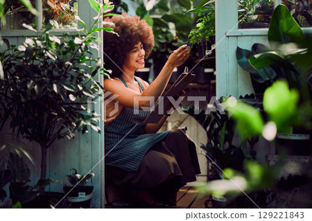 Woman entrepreneur, checklist and plants shop, check plants and growth development in job. Service, agriculture and black woman confirm quality control, farming or produce for health or eco friendly Woman entrepreneur, checklist and plants shop, check plants and growth development in job. Service, agriculture and black woman confirm quality control, farming or produce for health or eco friendly 129221843