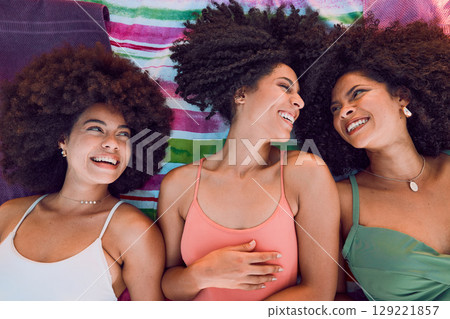 African women, happy and friends on floor for support, love and care or bonding together at beach. Black girls, smile and friendship happiness, laughing with afro and fun on summer holiday 129221857