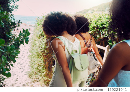 Friends walking to beach for summer travel, vacation and fun holiday together in sunshine. Back of black women, girl group and people traveling to sea sand, ocean and relax in fresh air of nature 129221941