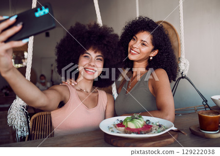 Black women, friends and phone selfie at restaurant, cafe or small business for social media. Relax, tech and females taking picture with mobile smartphone for happy memory or internet post. 129222038