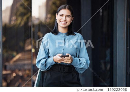 Phone, portrait and happy with a business woman typing a text message while standing outdoor on an office balcony. Social media, smile and communication with a female employee sending a mobile email Phone, portrait and happy with a business woman typing a text message while standing outdoor on an office balcony. Social media, smile and communication with a female employee sending a mobile email 129222068