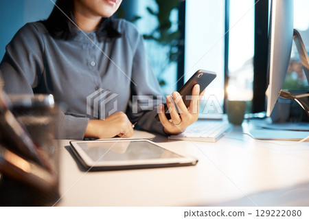 Tablet, phone and business woman at desk sitting in corporate office working online. Technology, digital marketing and hands of female worker using smartphone for research, internet and social media Tablet, phone and business woman at desk sitting in corporate office working online. Technology, digital marketing and hands of female worker using smartphone for research, internet and social media 129222080
