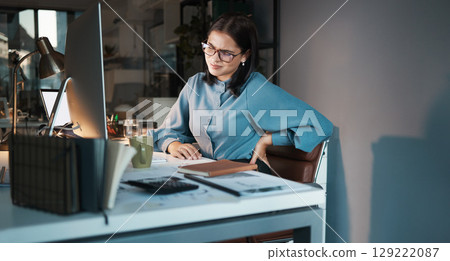 Business woman, computer or back pain in night office, digital marketing startup or advertising agency company. Tired, stress injury or worker on web design technology and sciatica crisis or burnout Business woman, computer or back pain in night office, digital marketing startup or advertising agency company. Tired, stress injury or worker on web design technology and sciatica crisis or burnout 129222087
