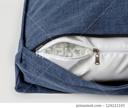 Open zipper showing cushion filling material on modern sofa Open zipper showing cushion filling material on modern sofa 129222105