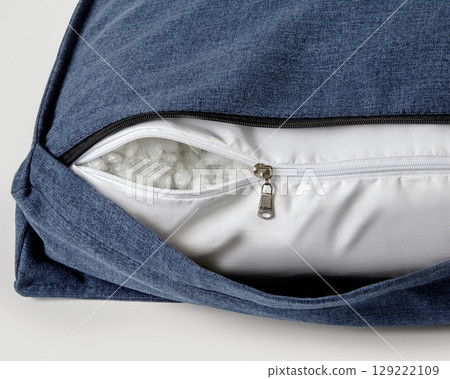 Open zipper showing filling of comfortable cushion Open zipper showing filling of comfortable cushion 129222109