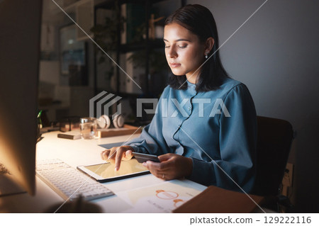 Online shopping, night and business woman with tablet typing in credit card details, payment and account data. Ecommerce, digital technology and girl by desk in dark office doing internet banking 129222116
