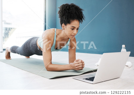 Wellness, fitness and yoga webinar on laptop for healthy and young black woman in body plank position. Focus, balance and online mindfulness in exercise class with girl on floor in home for health. Wellness, fitness and yoga webinar on laptop for healthy and young black woman in body plank position. Focus, balance and online mindfulness in exercise class with girl on floor in home for health. 129222135