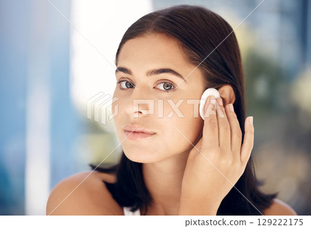 Makeup, woman skincare and cotton pad face cleaning of a model doing a wellness facial. Young female portrait with cosmetics, dermatology and youth beauty wash with skin glow and health shine 129222175