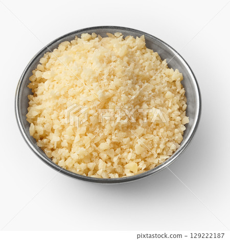 Grated parmesan cheese in a small metal bowl on white background 129222187