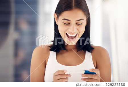 Excited, smile and woman with positive pregnancy test results with happy expression on face in bathroom. Family, love and pregnant girl with excitement for baby, child and future motherhood at home 129222188